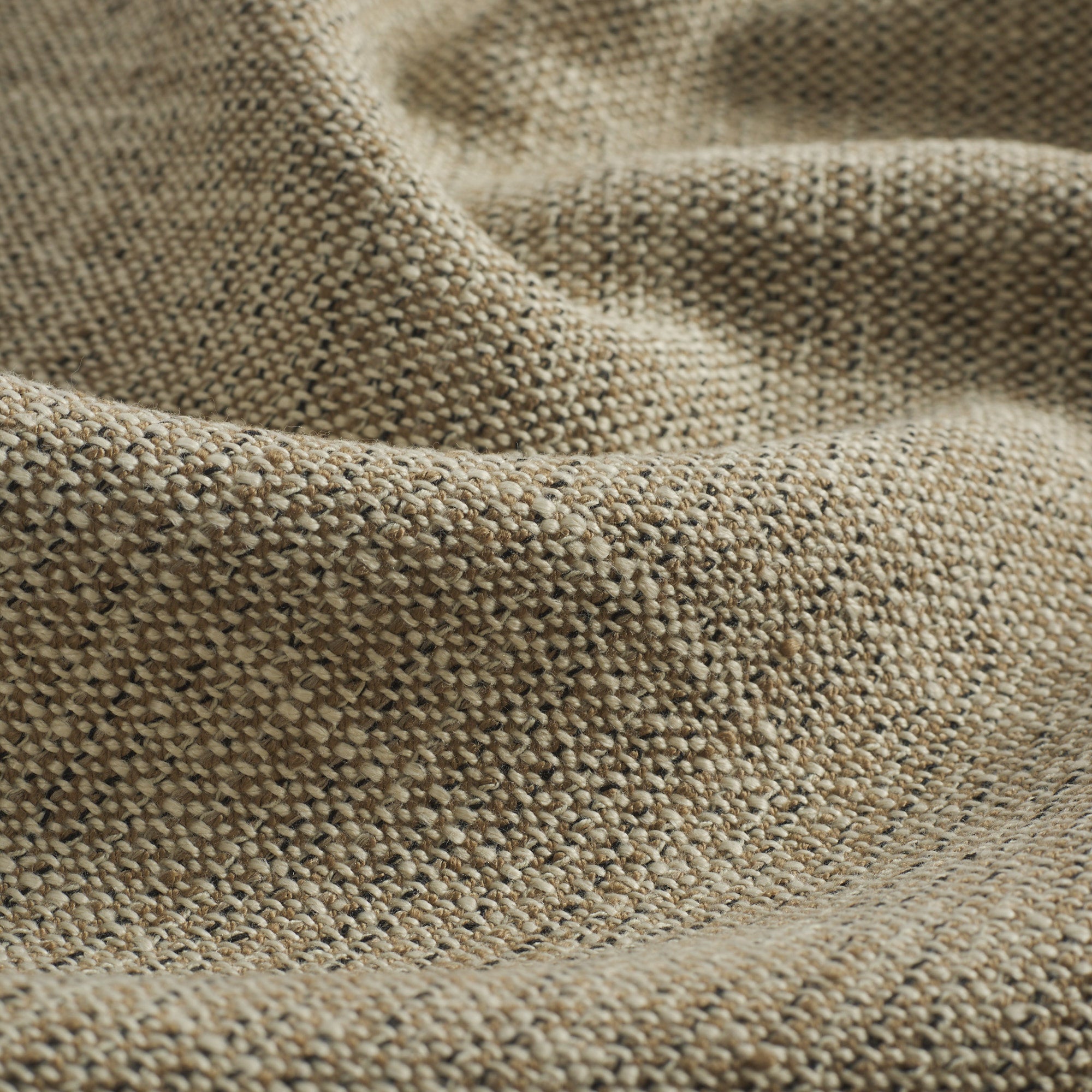 Close up of Tonic Living Troy InsideOut Tweed upholstery fabric highlighting its warm neutral textured weave.