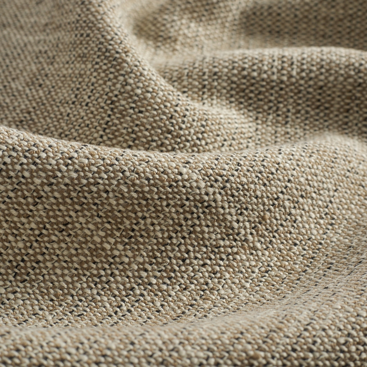 Close up of Tonic Living Troy InsideOut Tweed upholstery fabric highlighting its warm neutral textured weave.