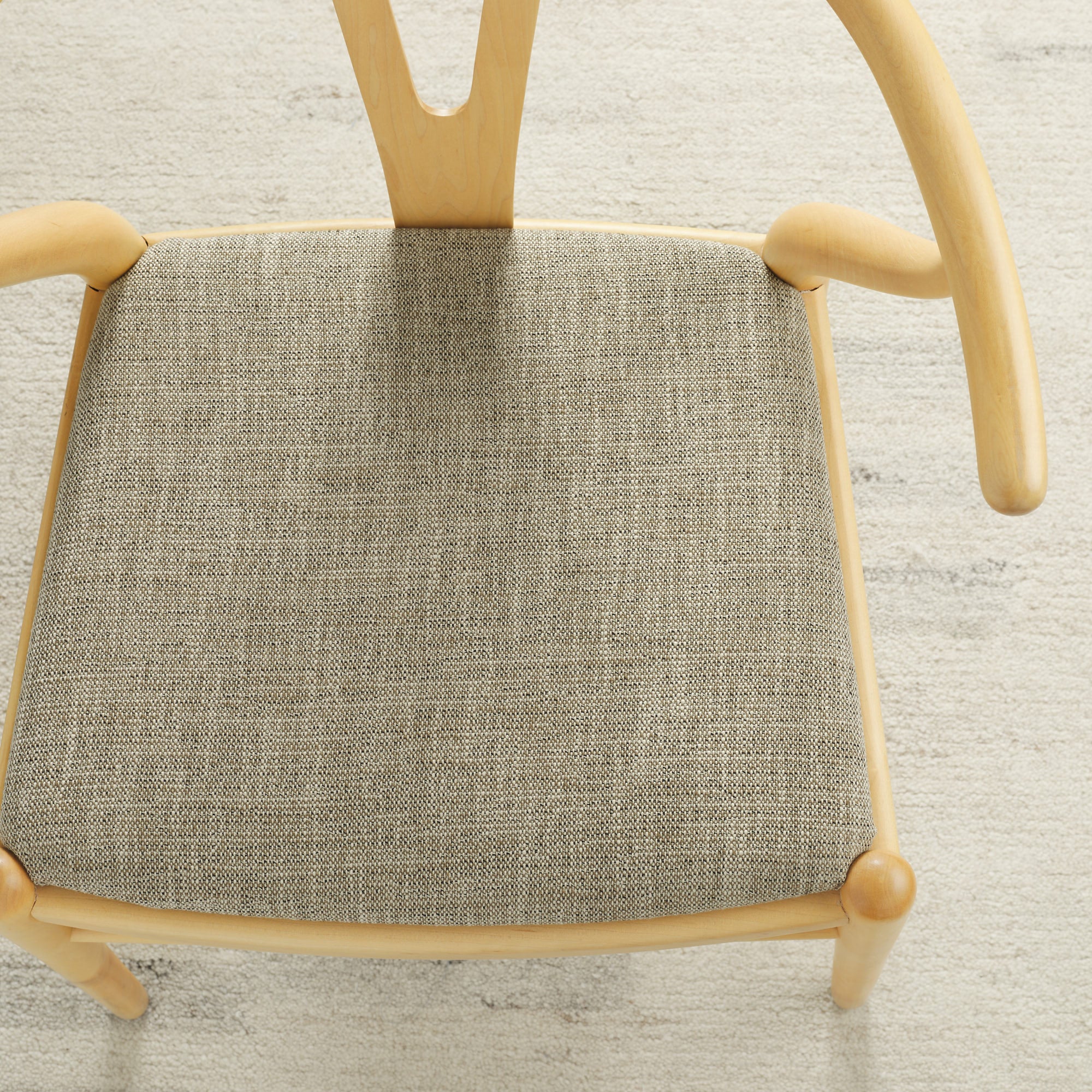 Tonic Living Troy InsideOut Tweed indoor/outdoor upholstery fabric on a dining chair seat in beige and brown tones.