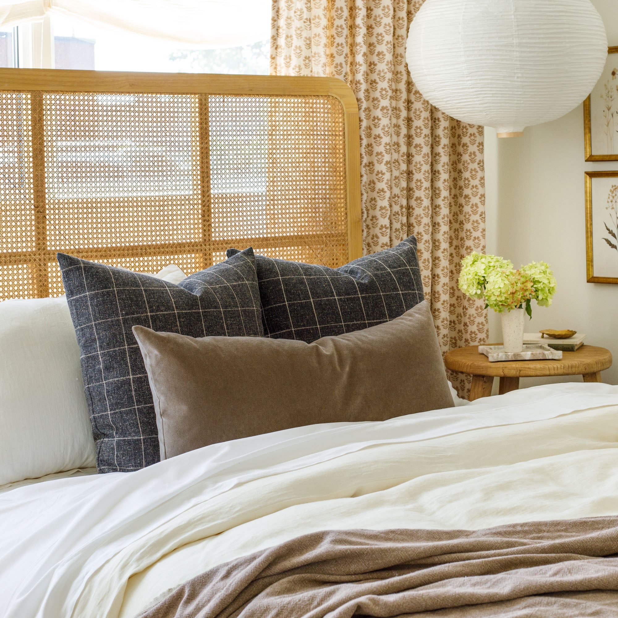 Tonic Living's dark and moody decorative throw pillows styled on a bed.