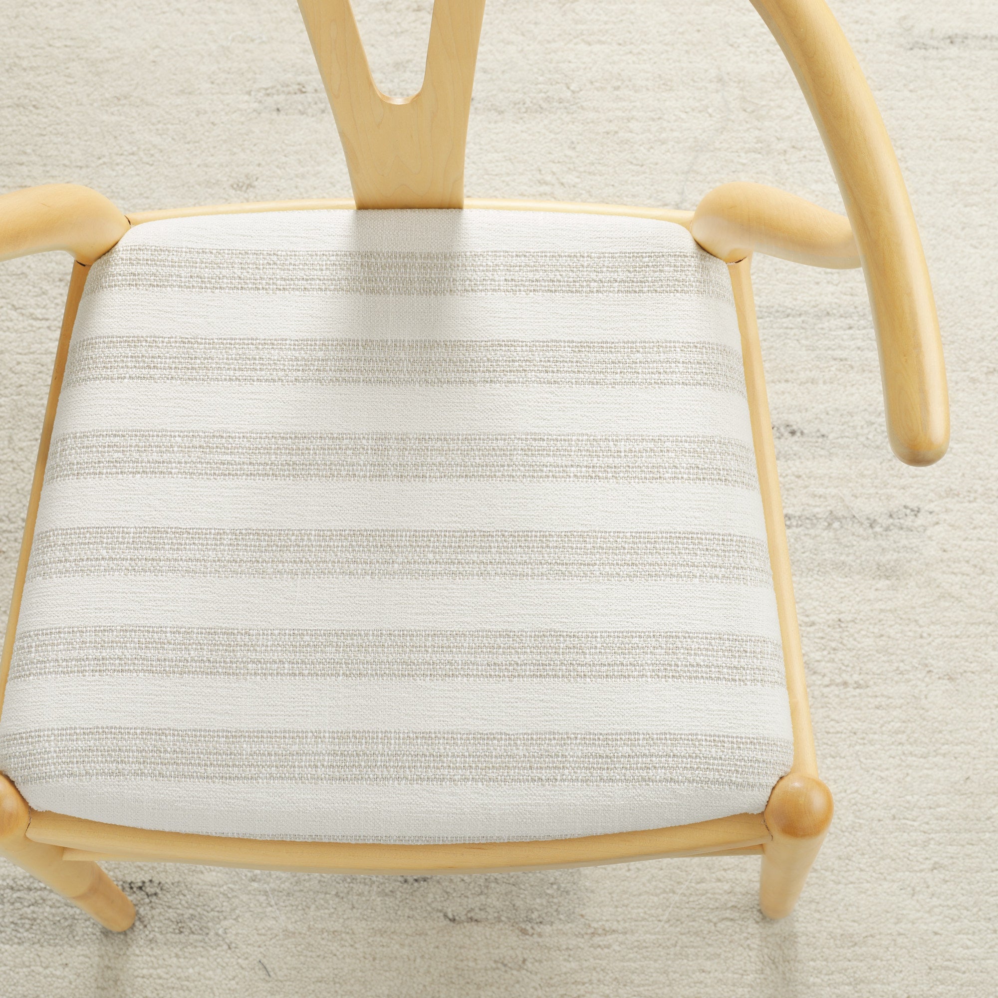 Tonic Living Vera InsideOut Pearl indoor/outdoor upholstery fabric on a dining chair seat in soft white stripe.