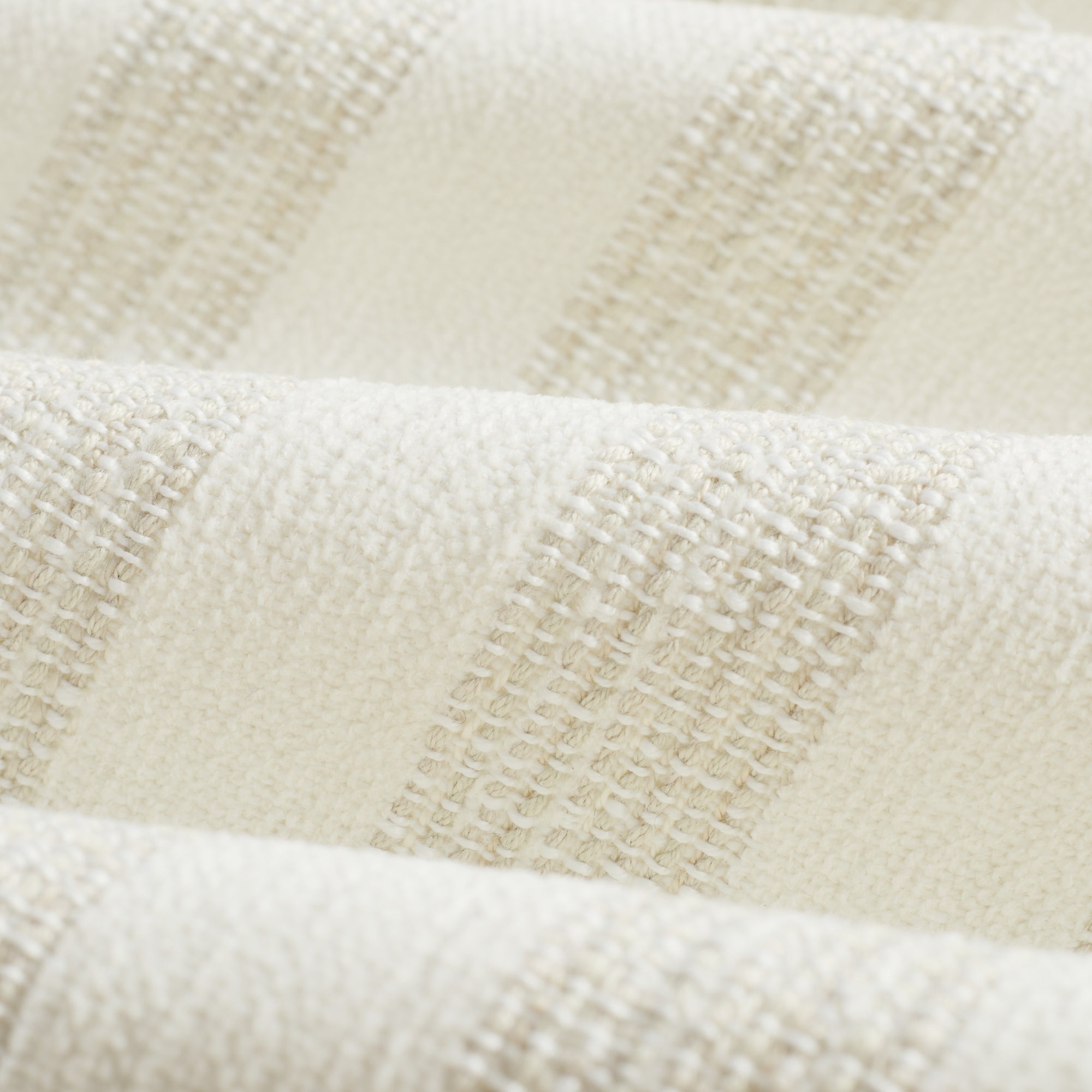 Tonic Living Vera InsideOut Pearl indoor/outdoor upholstery fabric on a dining chair seat in soft white stripe.