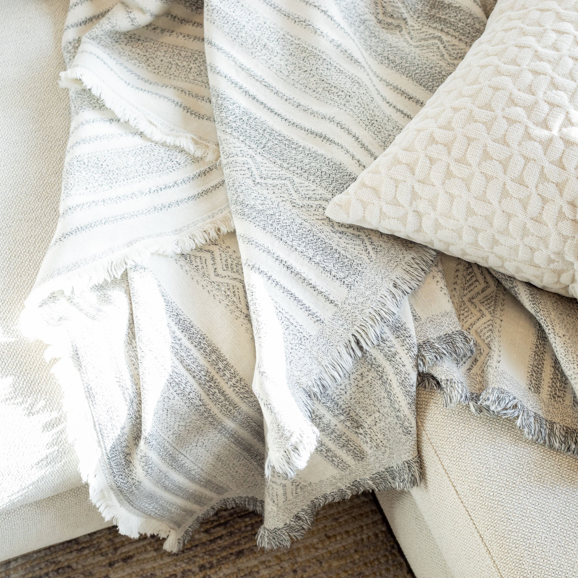 a cream and black wabi sabi striped throw blanket : close up view