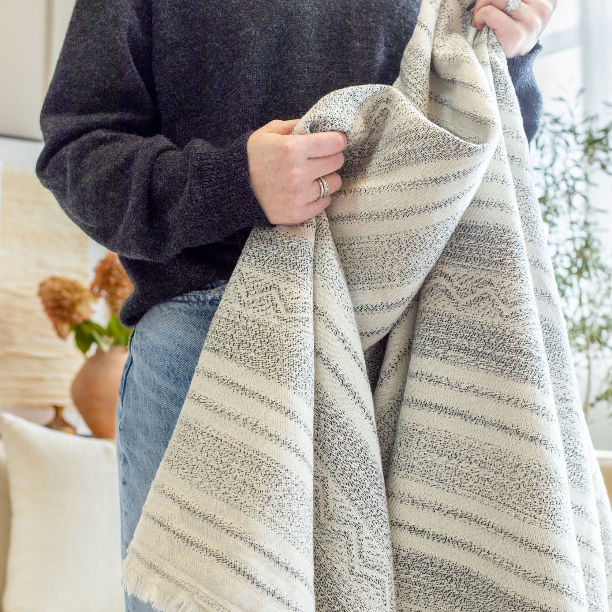 a cozy cream and black wabi sabi striped throw blanket