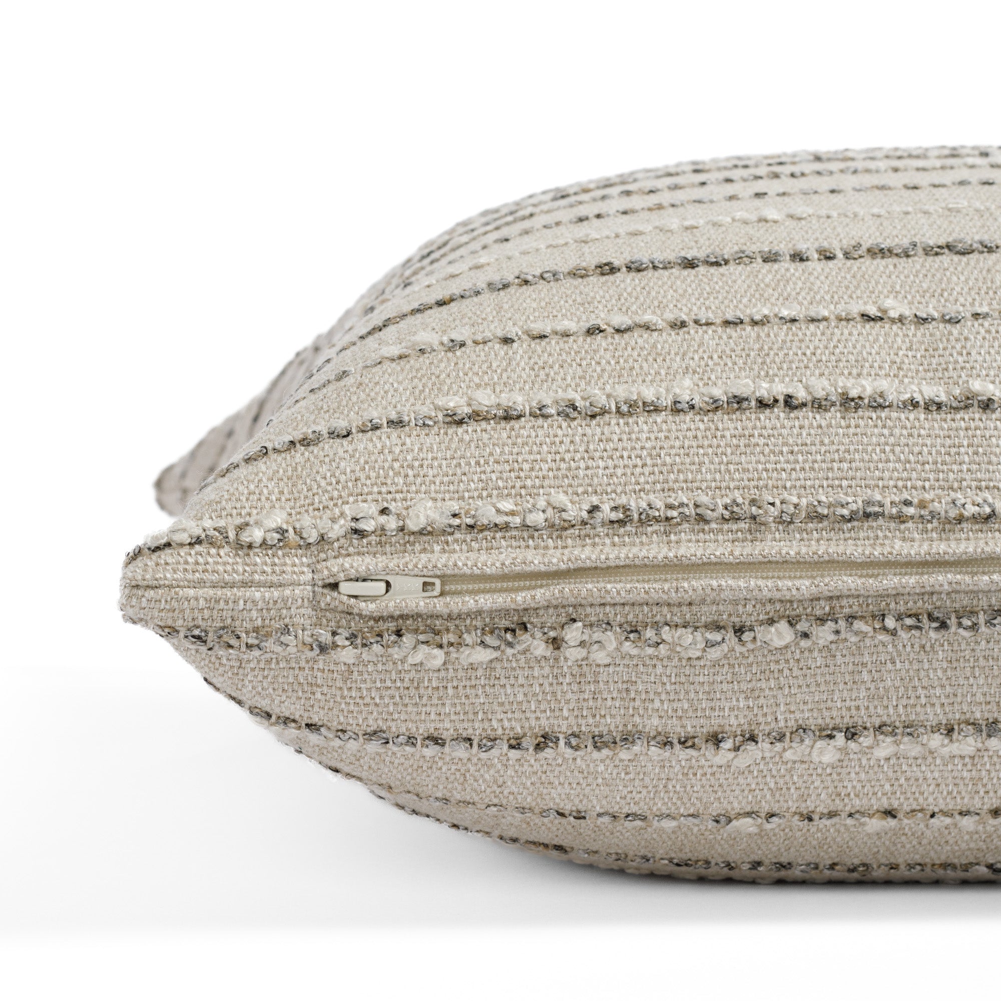 a neutral earth toned textured stripe : close up zipper detail