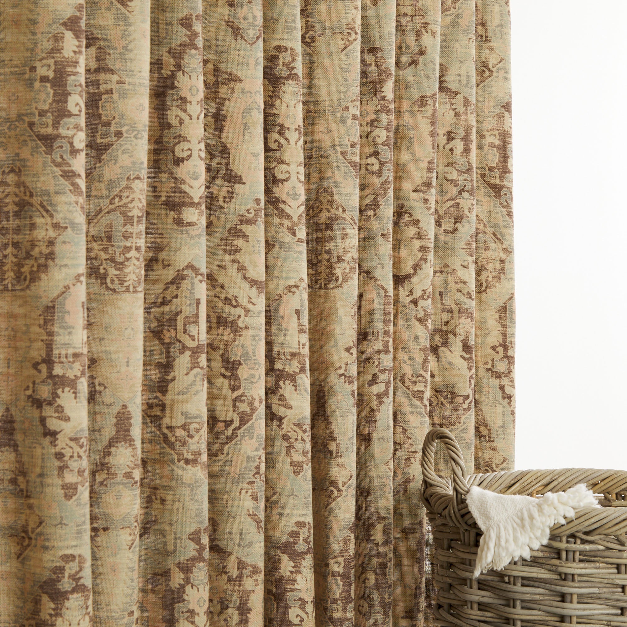 Tonic Living Zuri Driftwood drapery fabric shown as curtains featuring a timeworn ornamental medallion pattern.