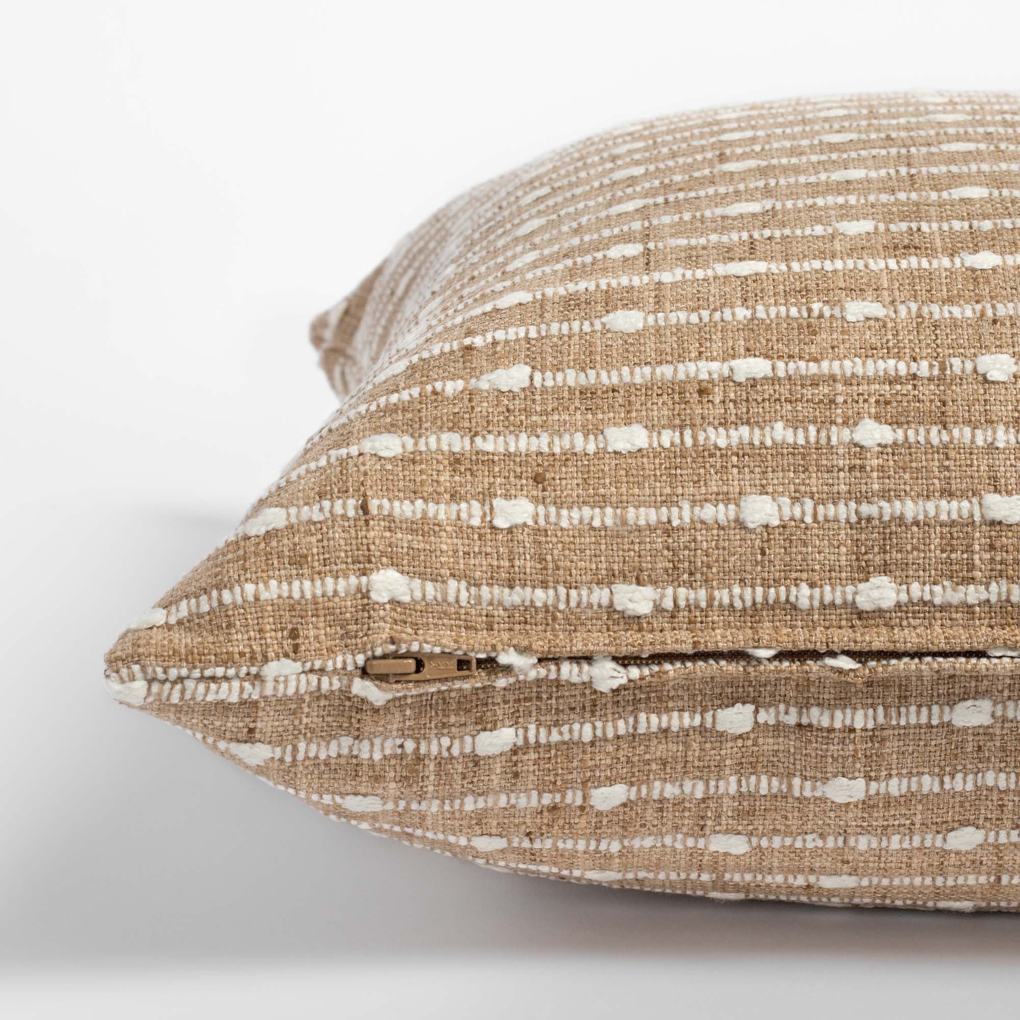 Arren Burlap, a camel pillow with cream horizontal stripes : zipper view