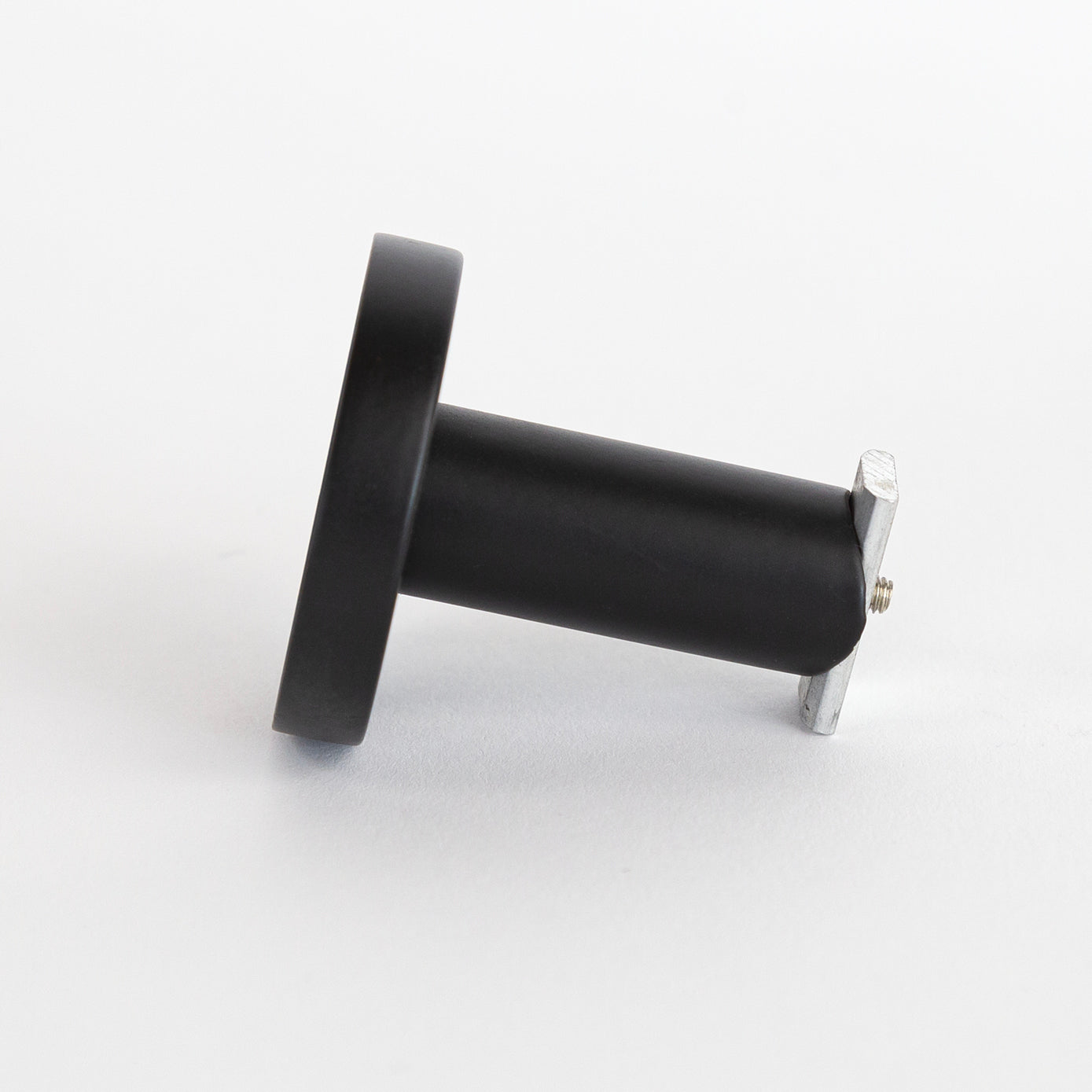 A black metal ceiling bracket for channel track drapery rods from Tonic Living