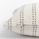 Elodie Felt, a cream with beige vertical dot stripes lumbar pillow : close up zipper  view