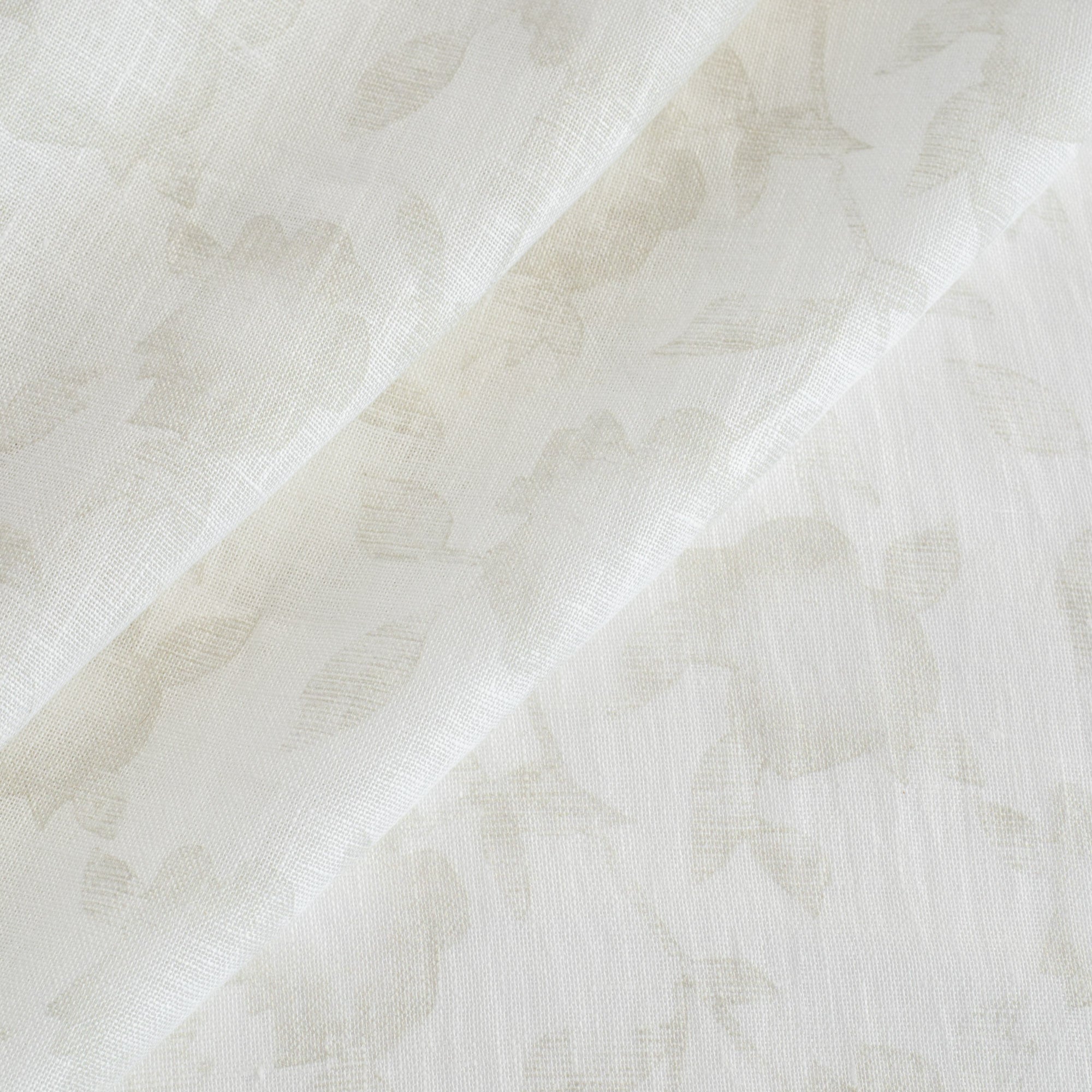 a cream white and beige floral print sheer fabric