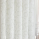 a white and beige floral print sheer fabric