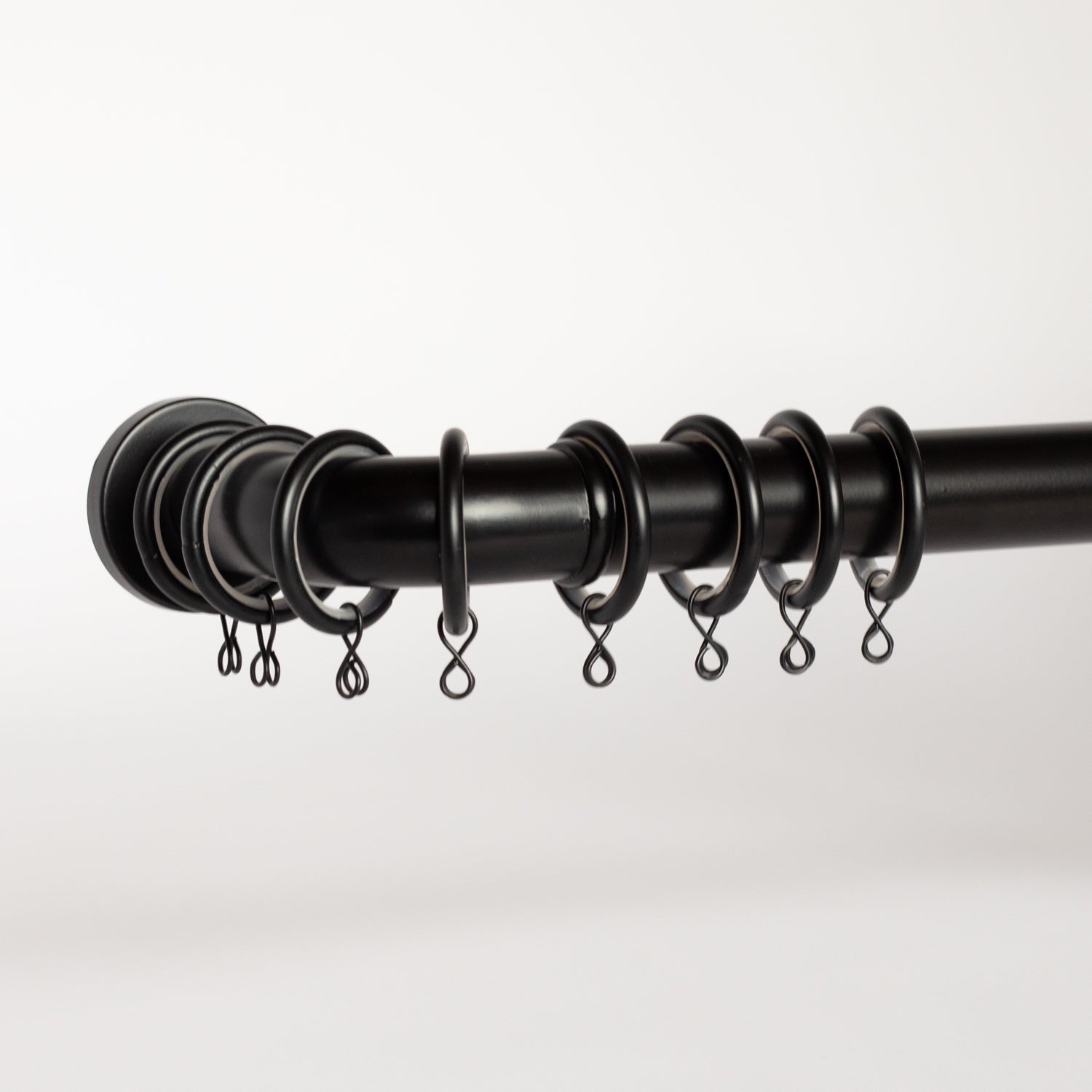 French Return Bracket for drapery rods shown with rod and rings