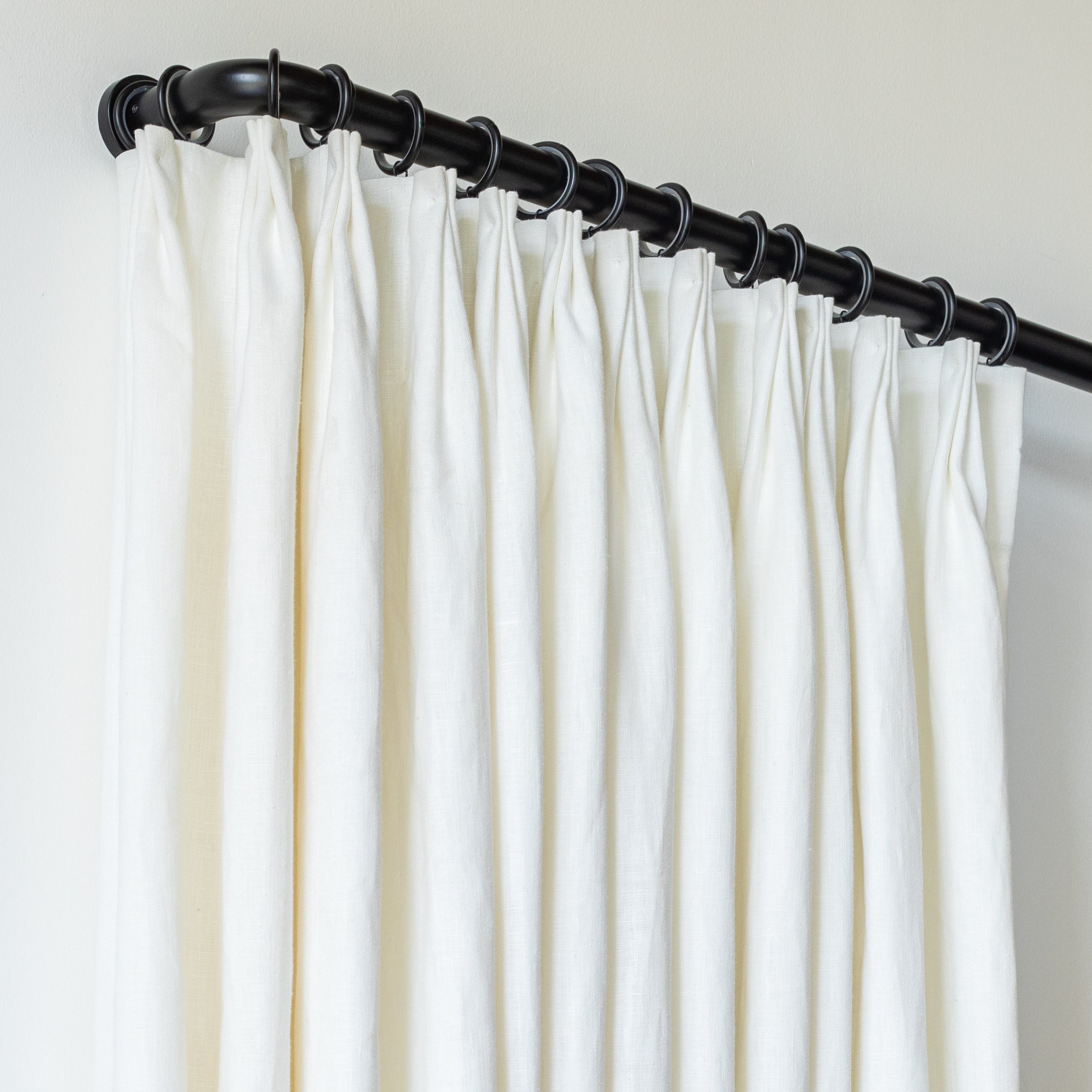 Drapes on black metal french return bracket