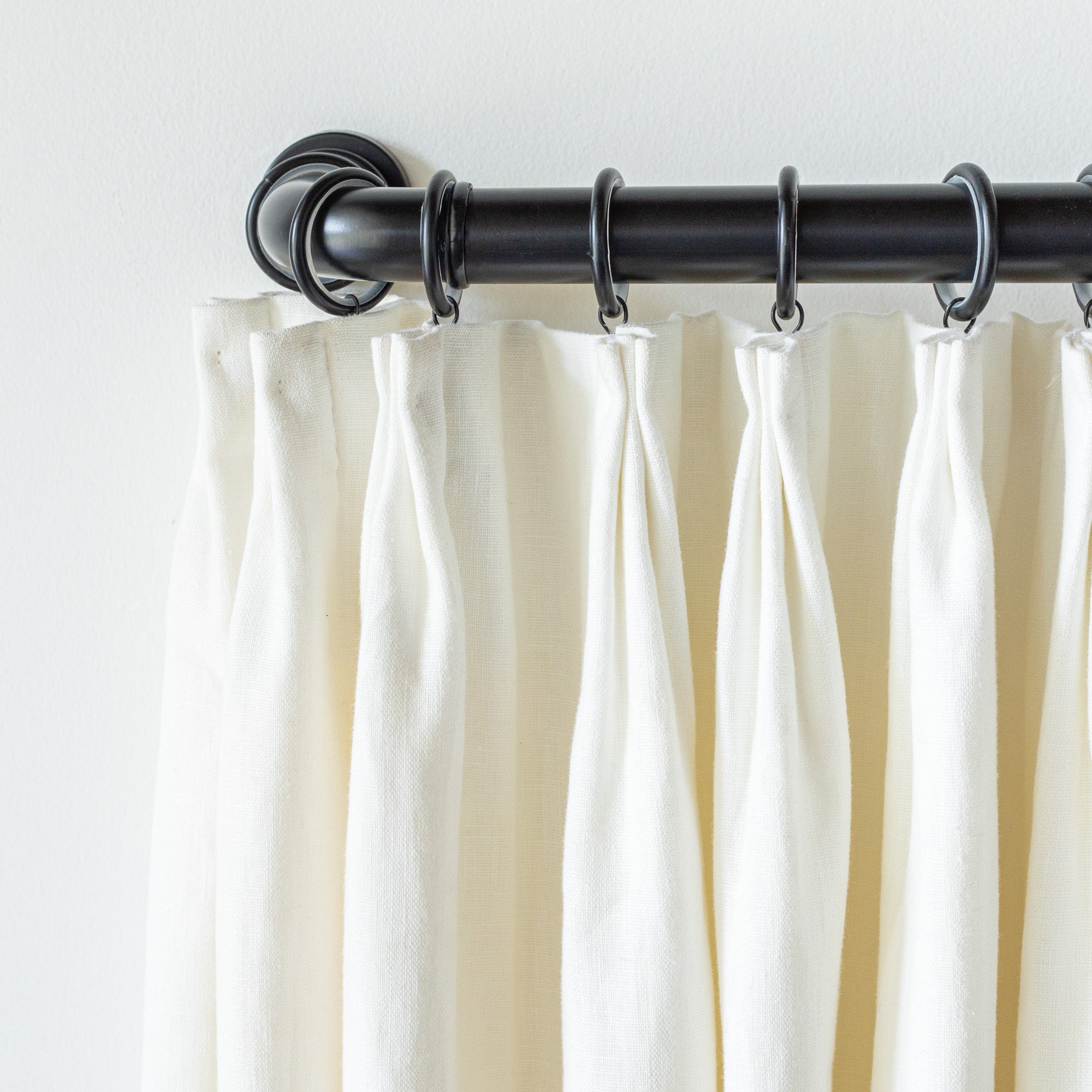 Drapes on black metal french return bracket