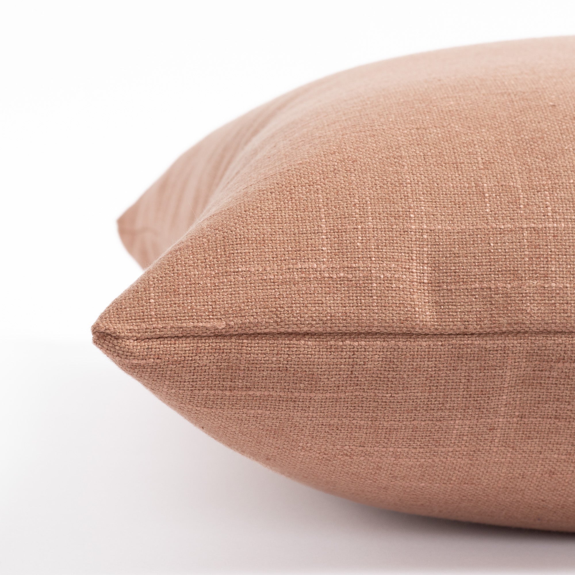 a terracotta orange pink throw pillow : side view