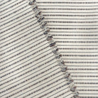 Misto Stripe Cream and Black, a cream and black striped Crypton home performance fabric : view with selvage edge