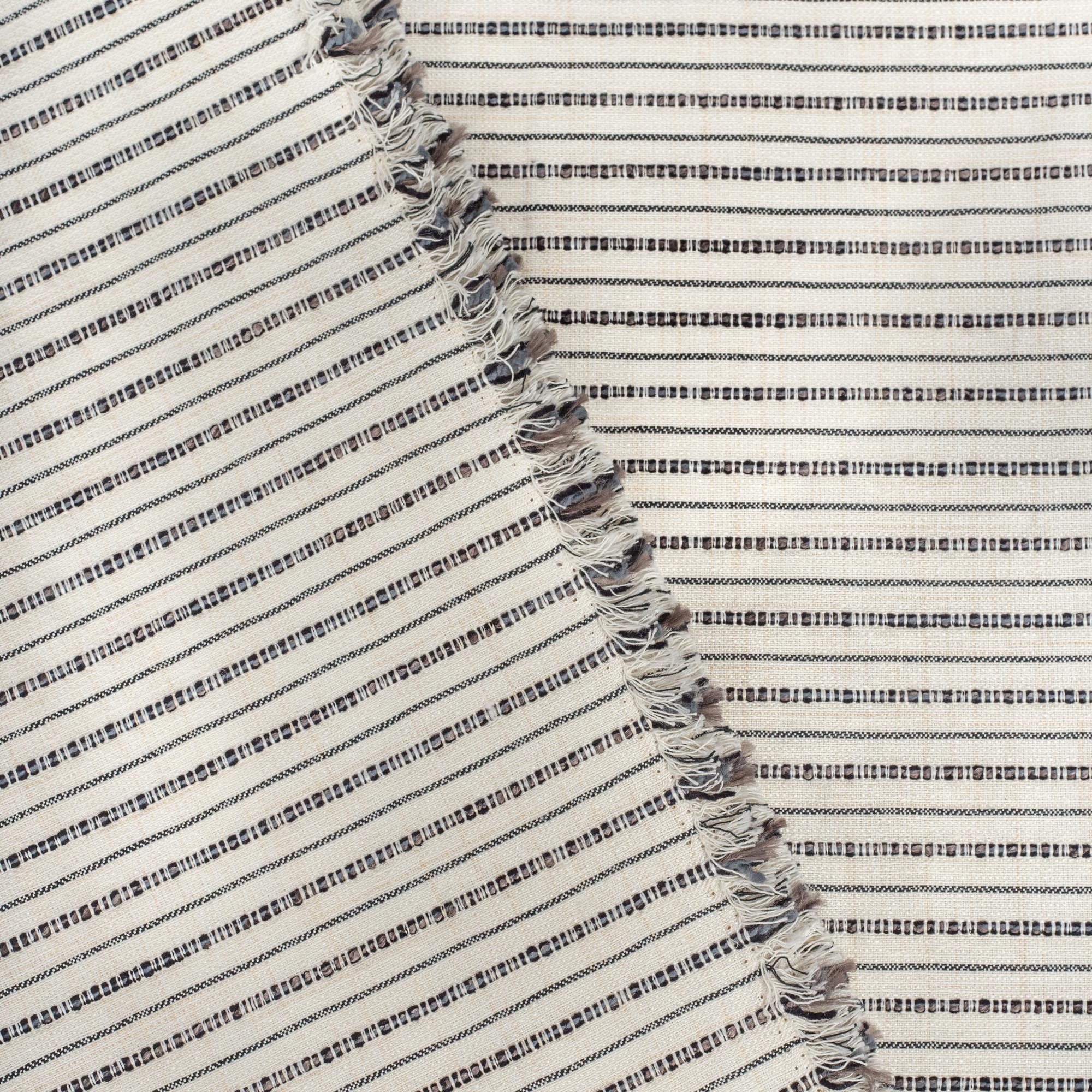 Misto Stripe Cream and Black, a cream and black striped Crypton home performance fabric : view with selvage edge