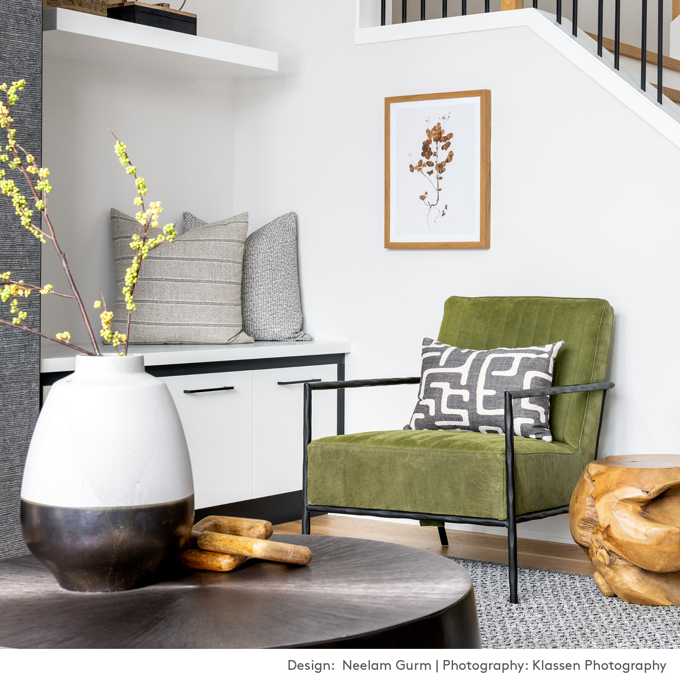 karru charcoal grey pillow on a green chair, with other grey tone pillows