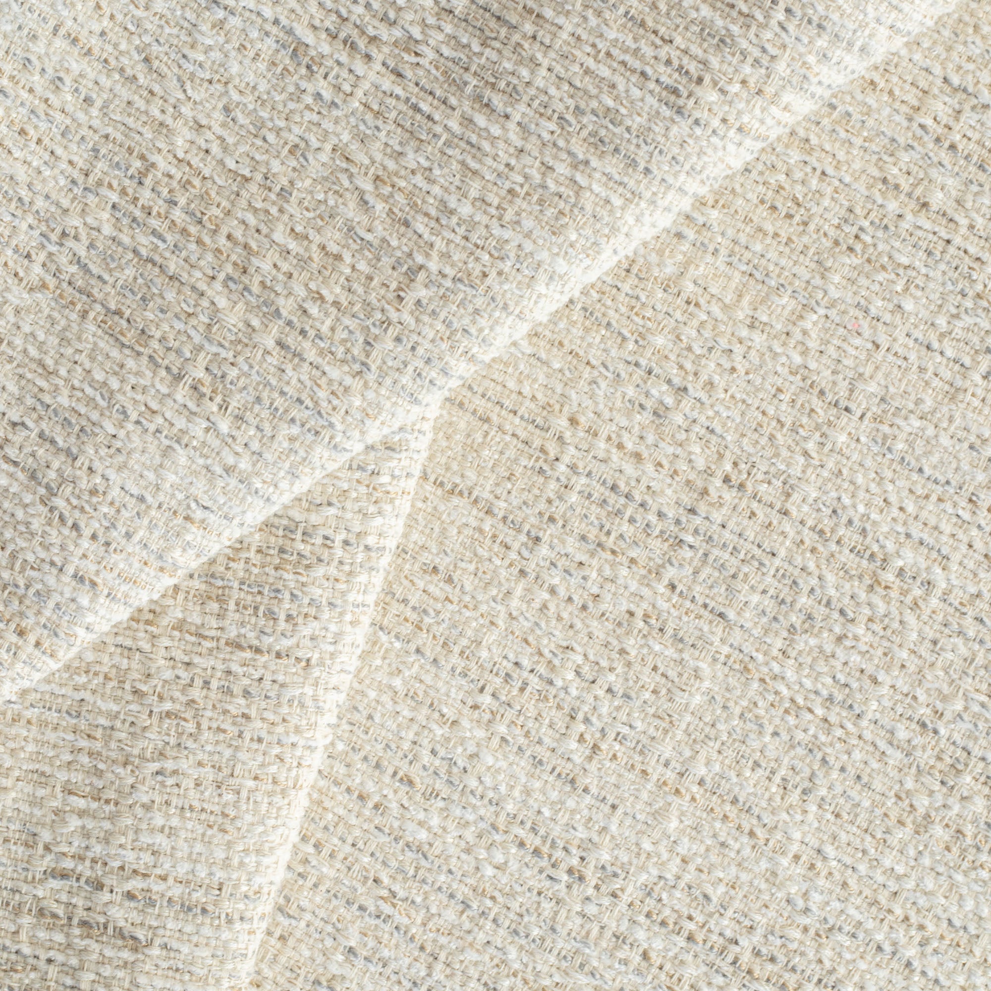 a beige textured woven upholstery fabric