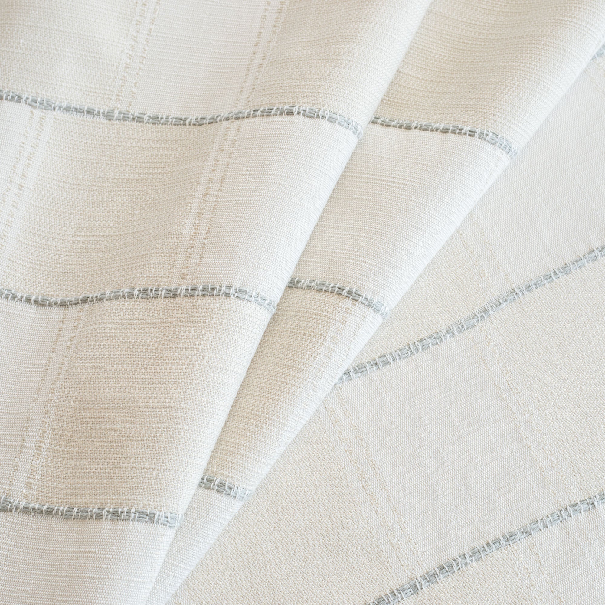 a cream and off white check fabric with a chunky light blue horizontal stripe