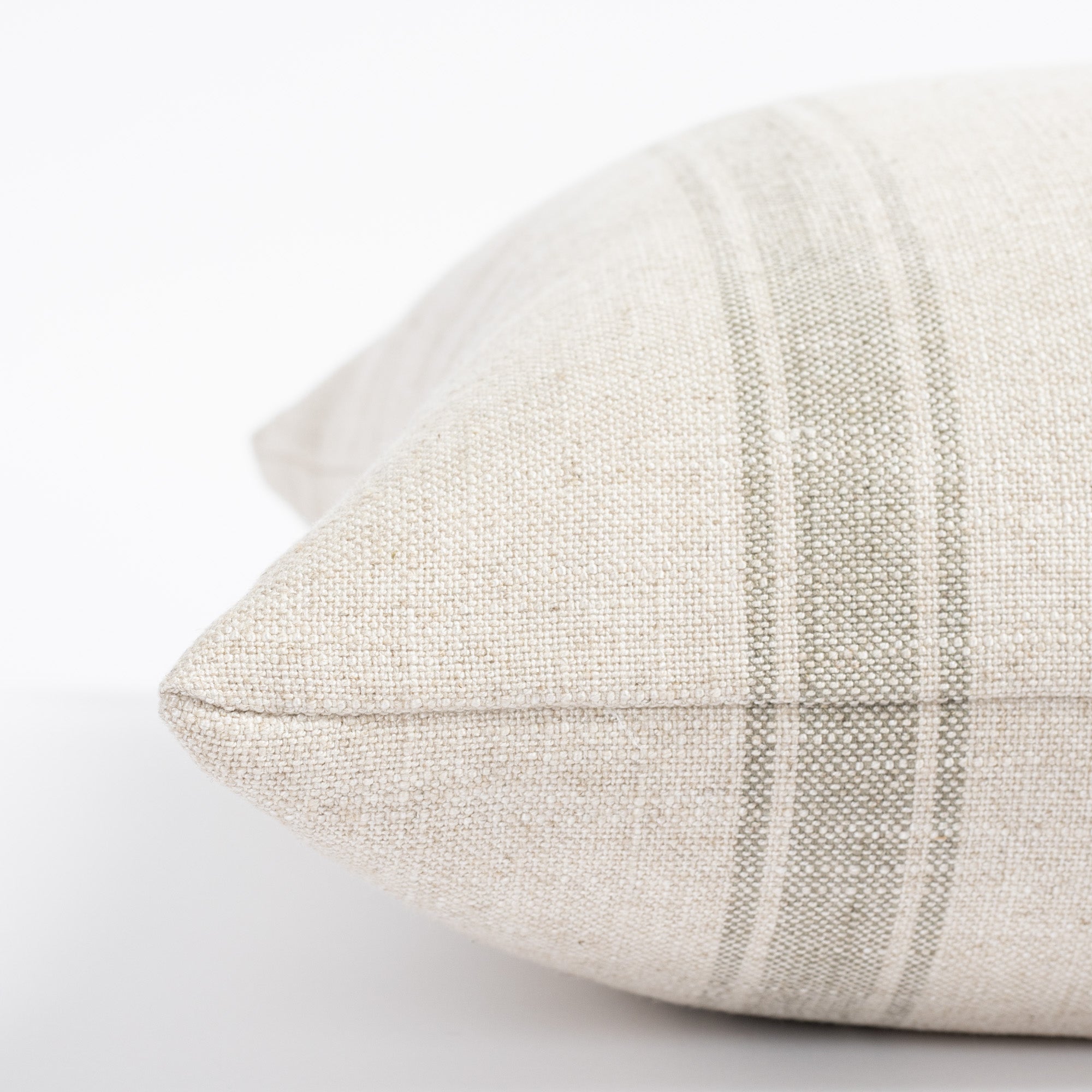 a cream and watery blue green stripe throw pillow : close up side view