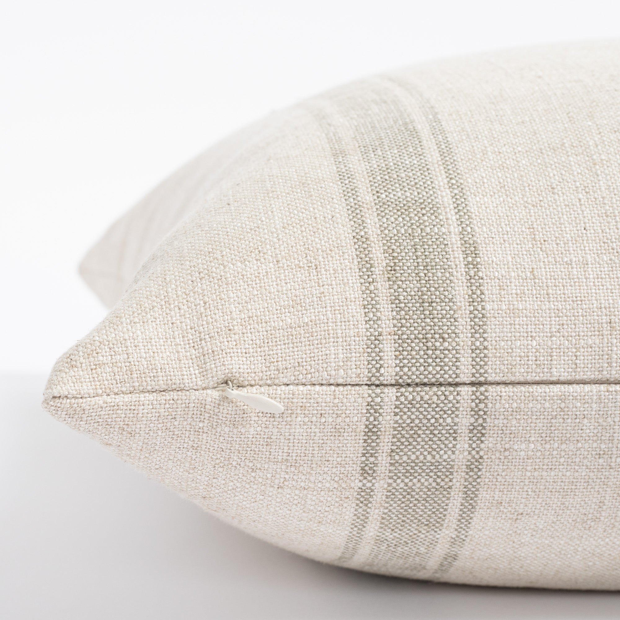 a cream and watery blue green stripe throw pillow : close up zipper view