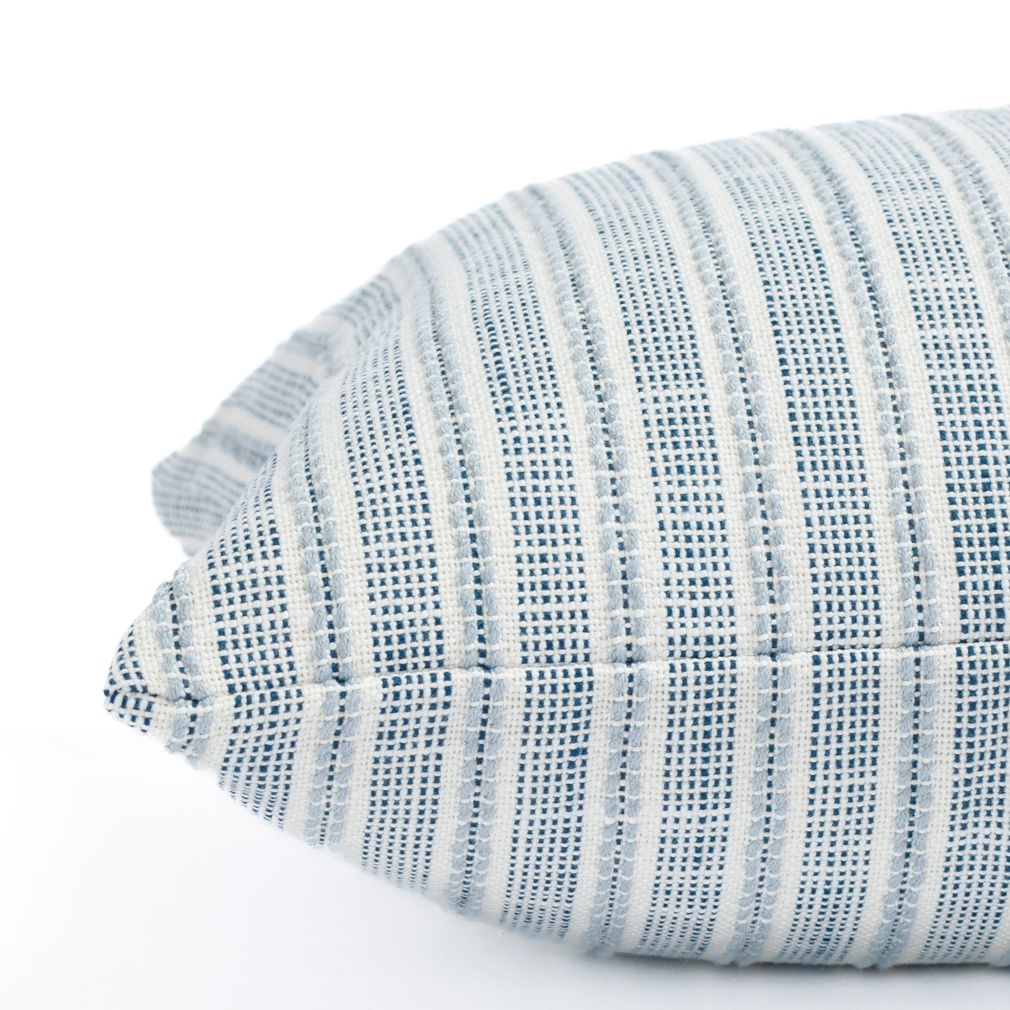 a white and blue outdoor throw pillow : close up side view