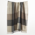 Tonic Living Angus Check Wool Throw Blanket in Mink, a brown, grey, and beige checked wool blanket with fringed edges.