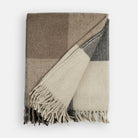 Folded Tonic Living Angus Check Wool Throw Blanket in Mink featuring a classic brown, grey, and beige check pattern.