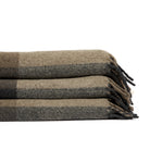 Stack of folded Tonic Living Angus Check wool throw blankets in Mink featuring brown, grey, and beige checks with fringed edges.