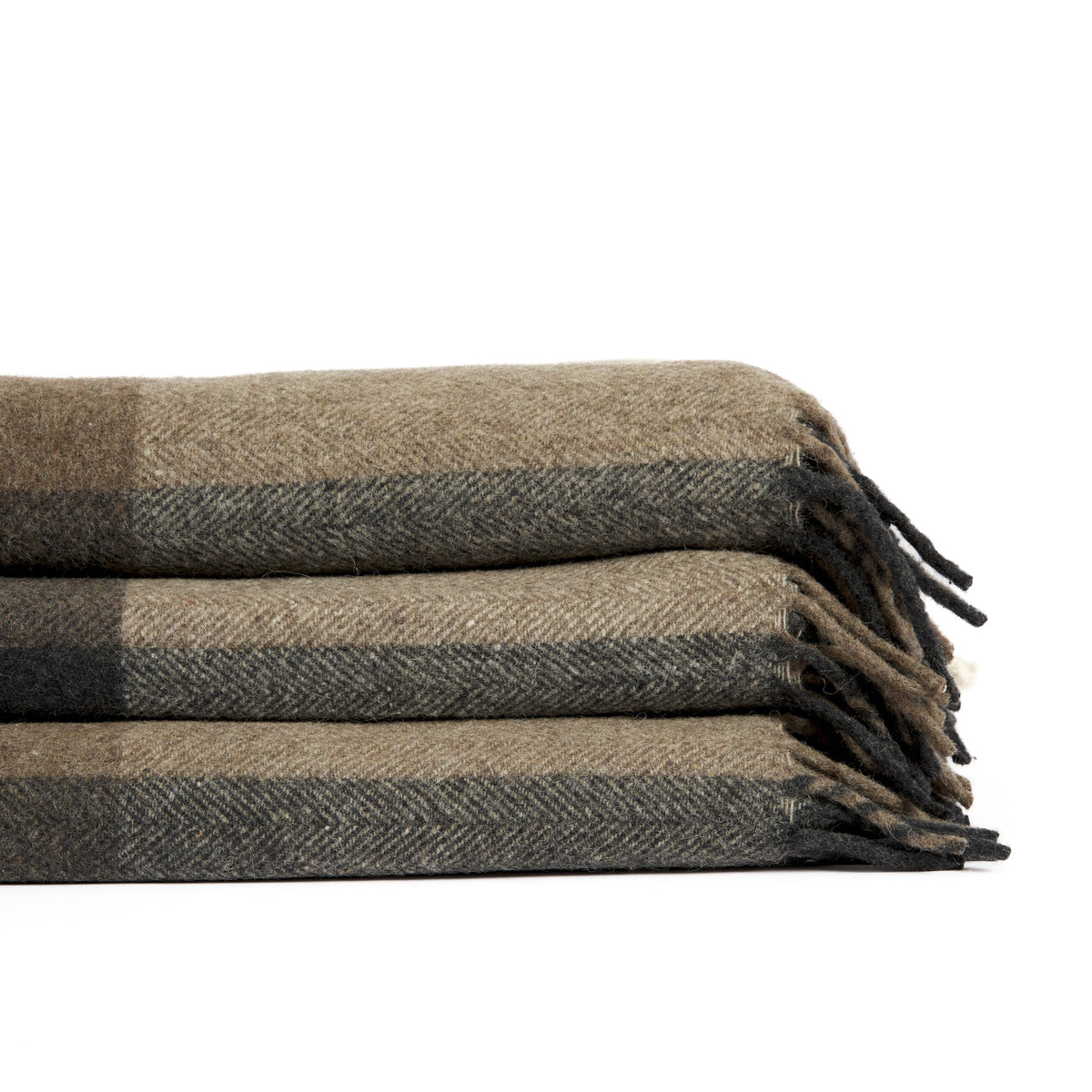 Stack of folded Tonic Living Angus Check wool throw blankets in Mink featuring brown, grey, and beige checks with fringed edges.