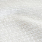a white basket weave textured upholstery fabric : close up view