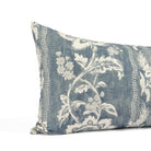 Close up of Tonic Living Ashford bed bolster showing scrolling floral vine detail in chambray blue and white.