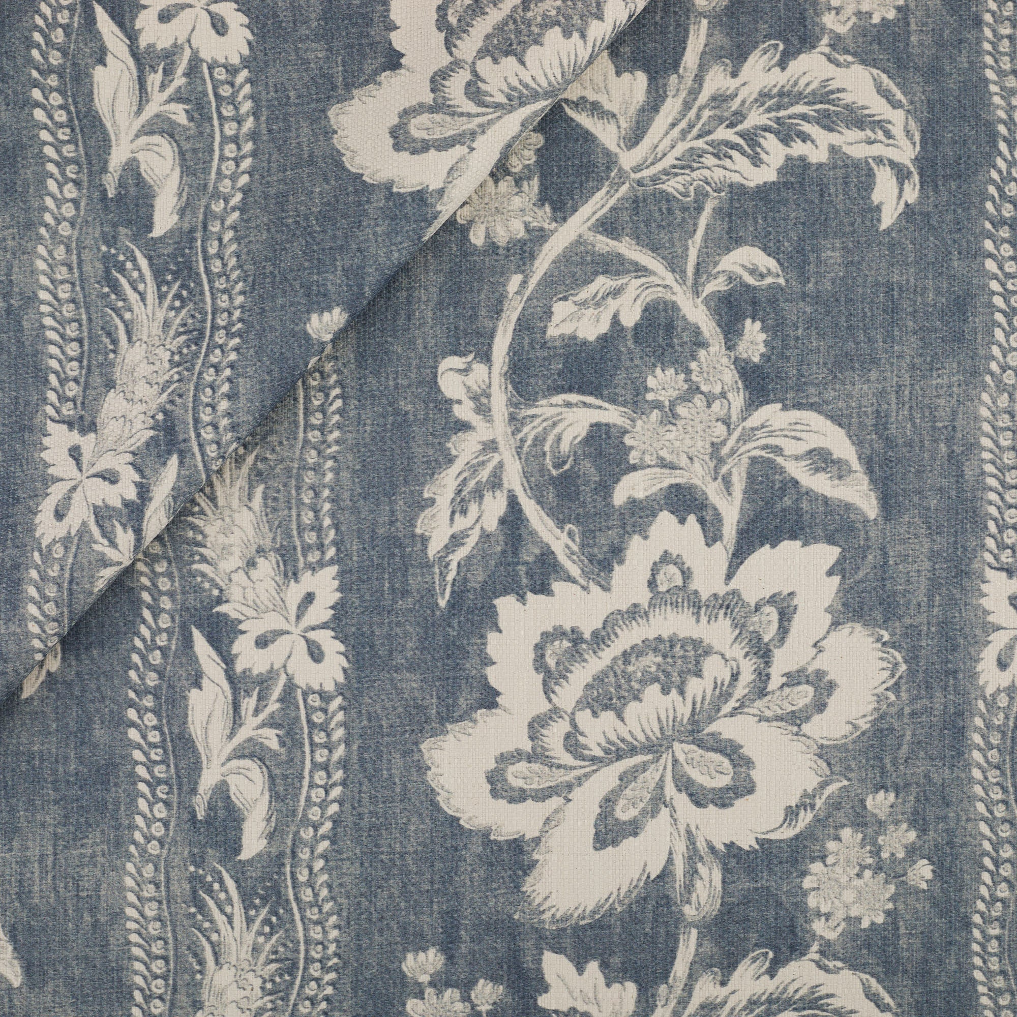 Tonic Living Ashford Fabric in Denim, a chambray blue and white floral upholstery fabric with scrolling vine stripe.
