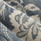 Close up of Tonic Living Ashford Denim fabric showing blue and white scrolling floral vine pattern.