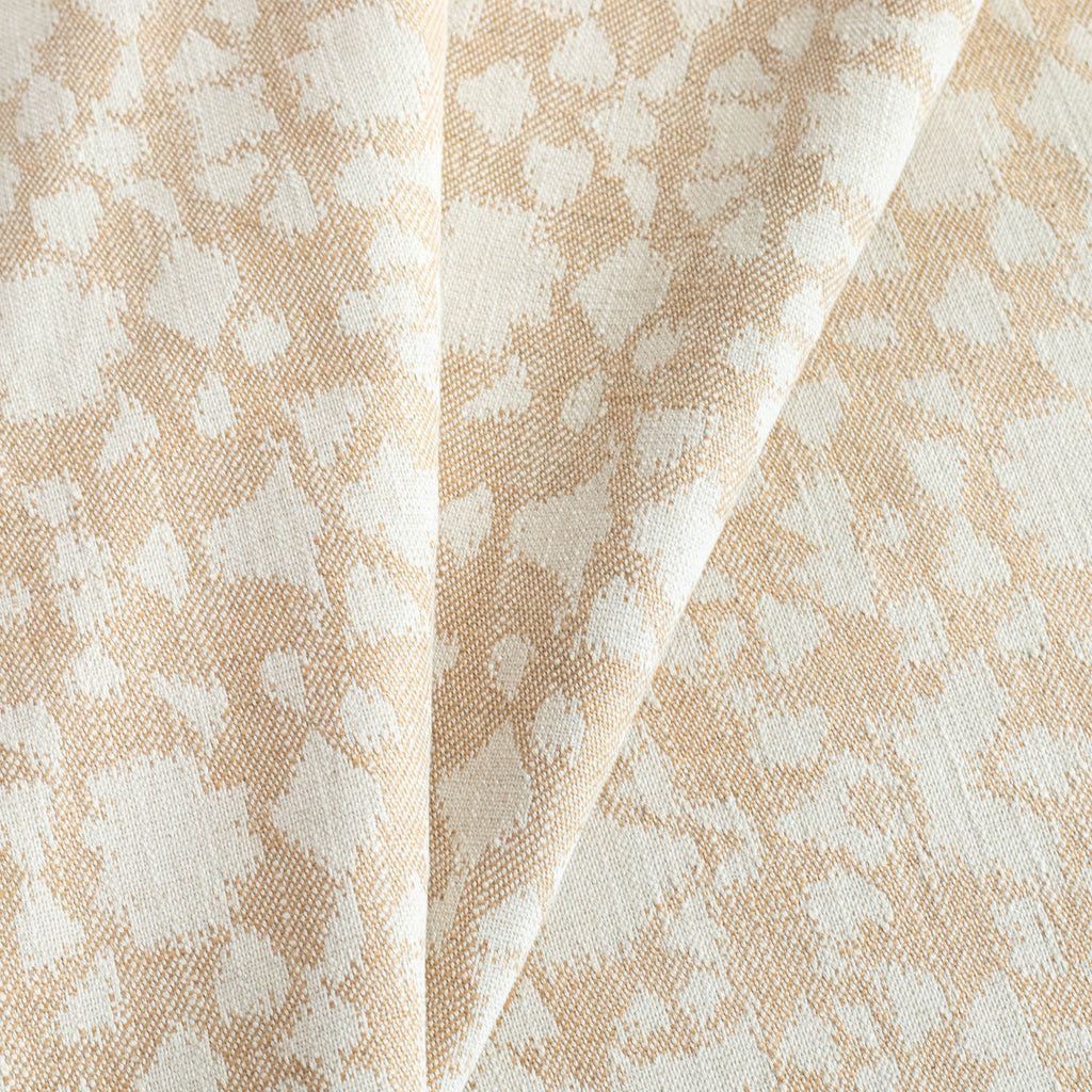 Astrid Cornsilk, a warm gold and oatmeal abstract botanical motif pattern upholstery fabric from Tonic Living