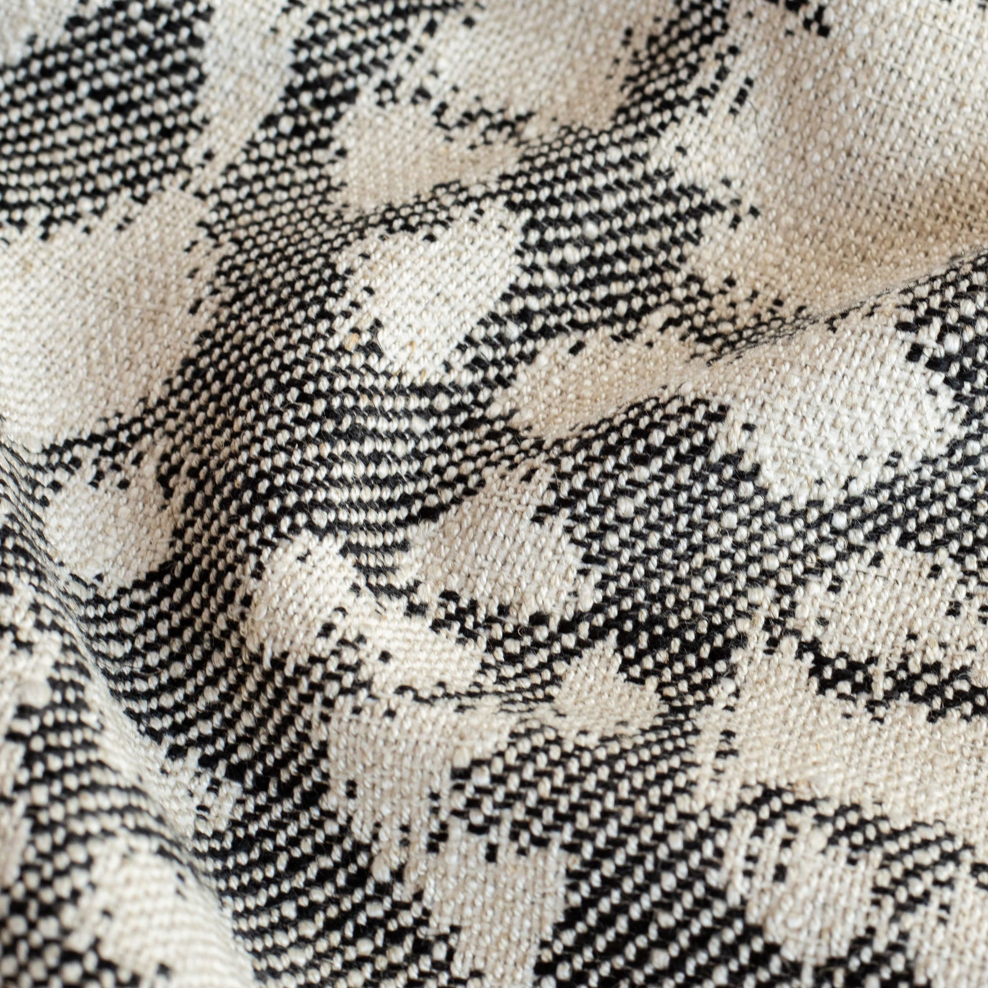 a black and cream pattern fabric 