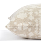 a greige and cream abstract floral print throw pillow: close up side view