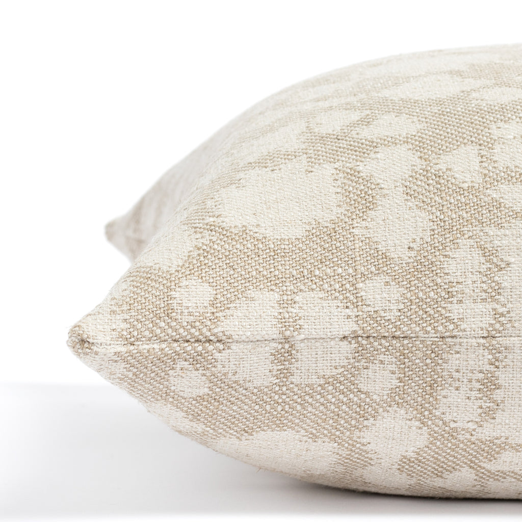 a greige and cream abstract floral print throw pillow: close up side view