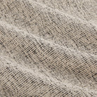 Detailed view of Atlas Fabric Salt & Pepper, fade-resistant off-white and black textured fabric by Tonic Living.