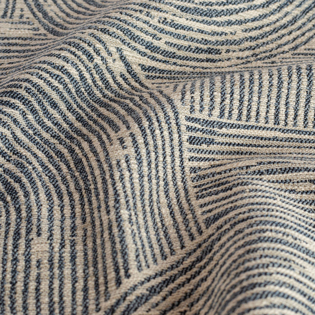 a geometic indigo blue and warm grey swirling patterned upholstery fabric: close up view