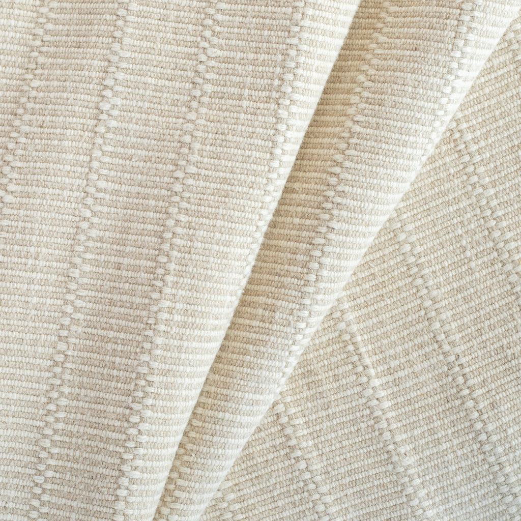 a beige and cream neutral tonal textured woven striped upholstery fabric