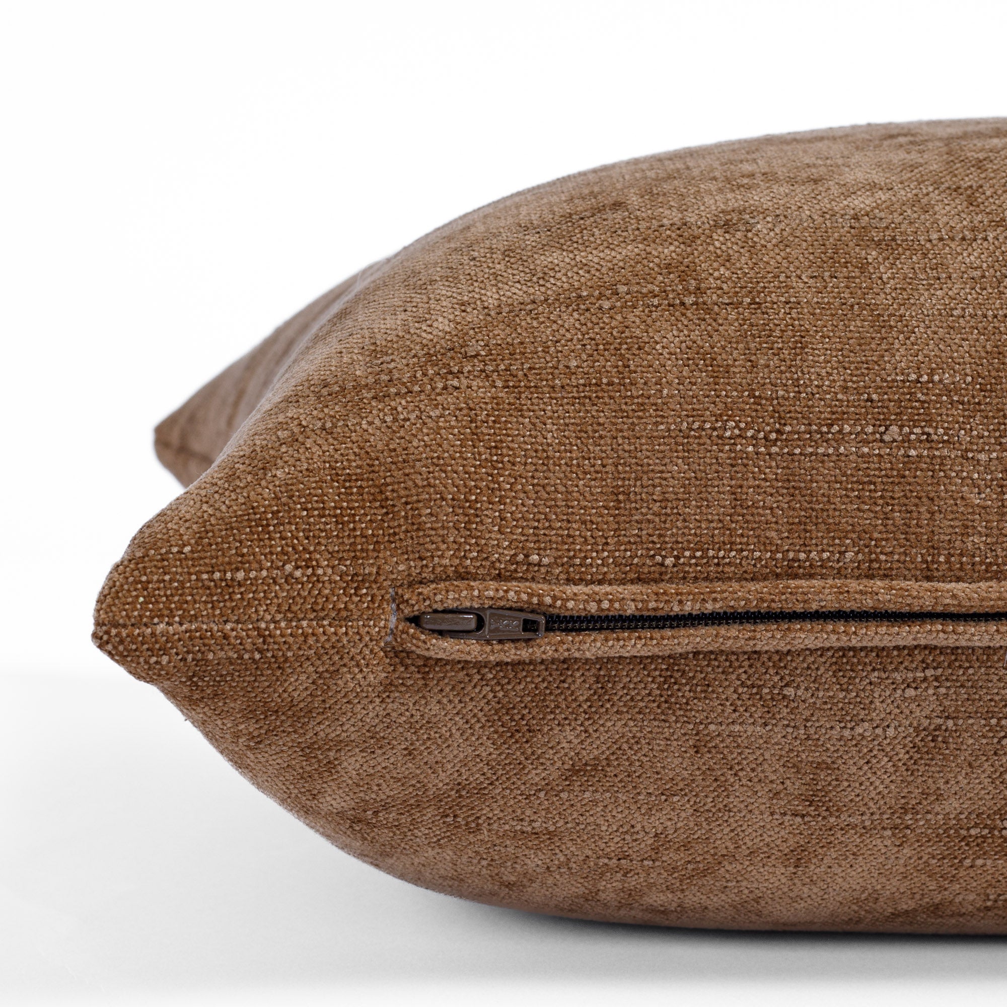 a cinnamon brown chenille lumbar pillow : close up zipper view