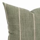 a leafy green throw pillow with a chunky natural stripe: close up view