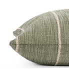 a leafy green throw pillow with a chunky natural stripe: close up side view