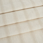 Tonic Living Brunswick Stripe fabric in cream shown as roman shades with a clean, tailored stripe.