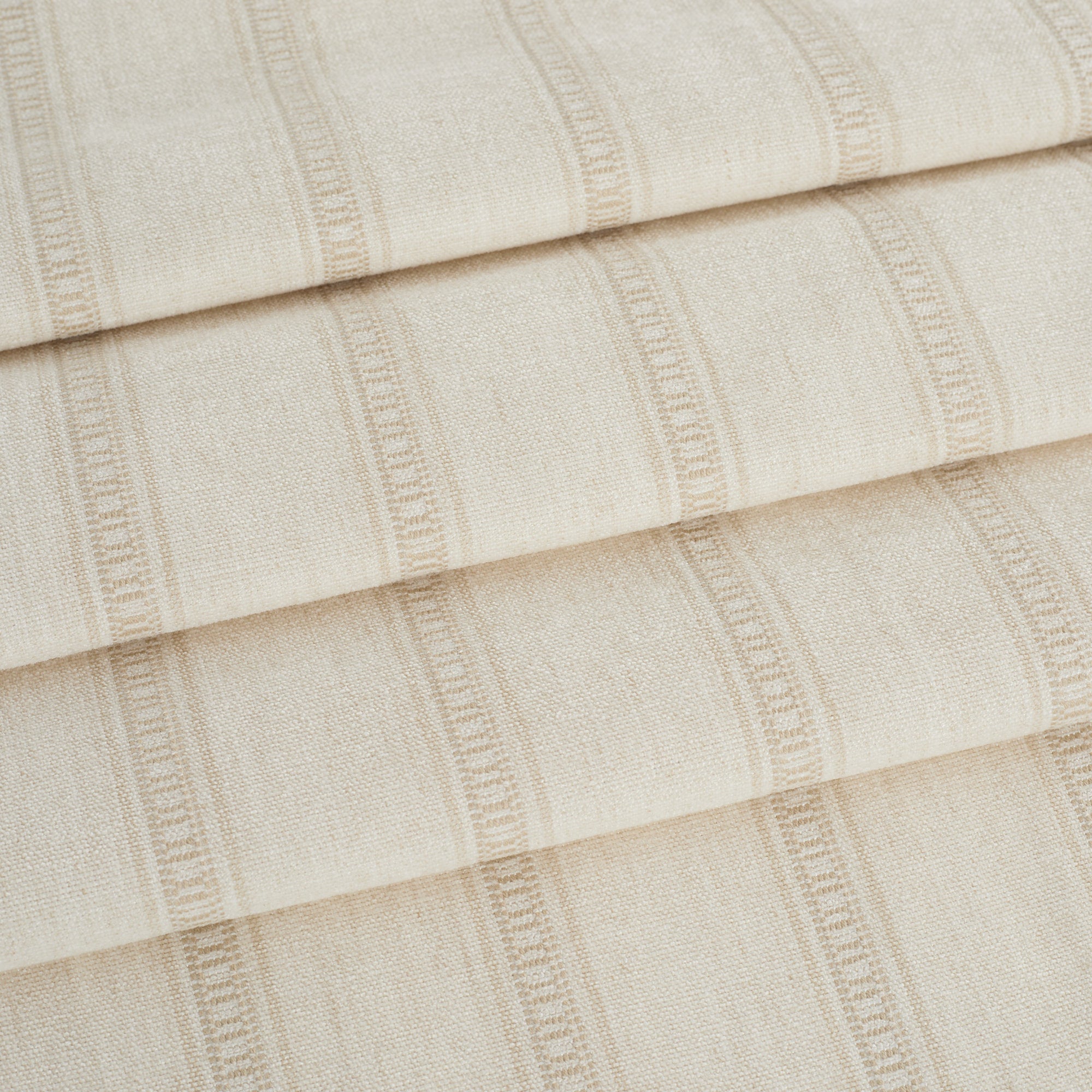 Tonic Living Brunswick Stripe fabric in cream shown as roman shades with a clean, tailored stripe.