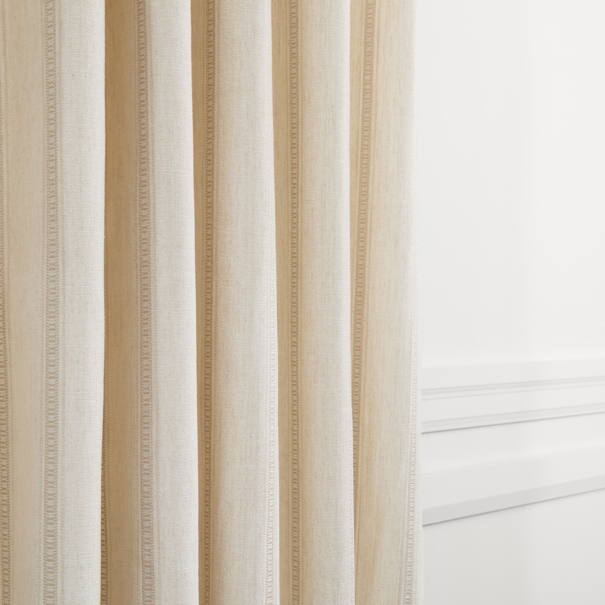 Tonic Living Brunswick Stripe fabric in Parchment sewn as drapery for a soft, neutral window look.