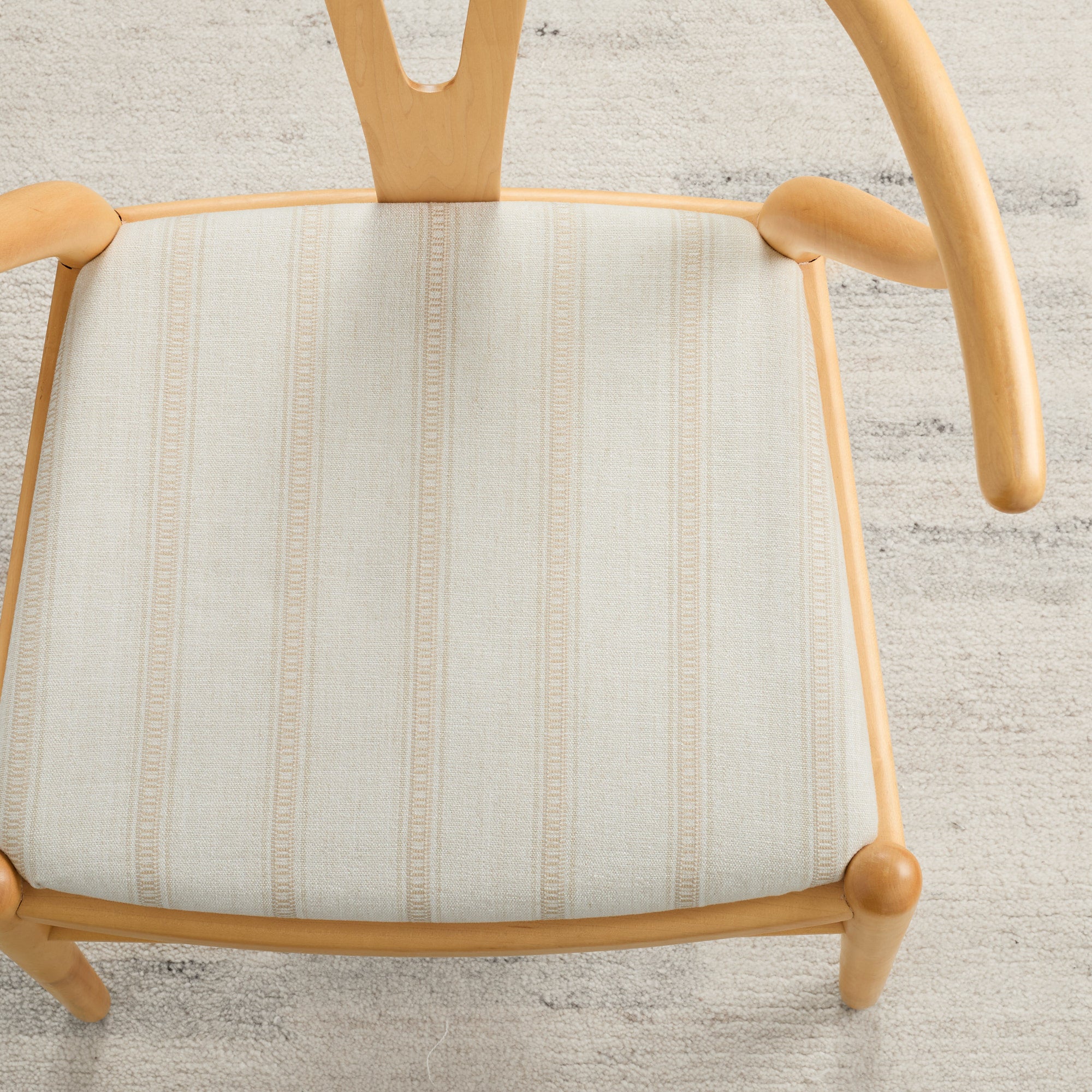 Tonic Living Brunswick Stripe upholstery fabric in Parchment shown on a dining chair seat.