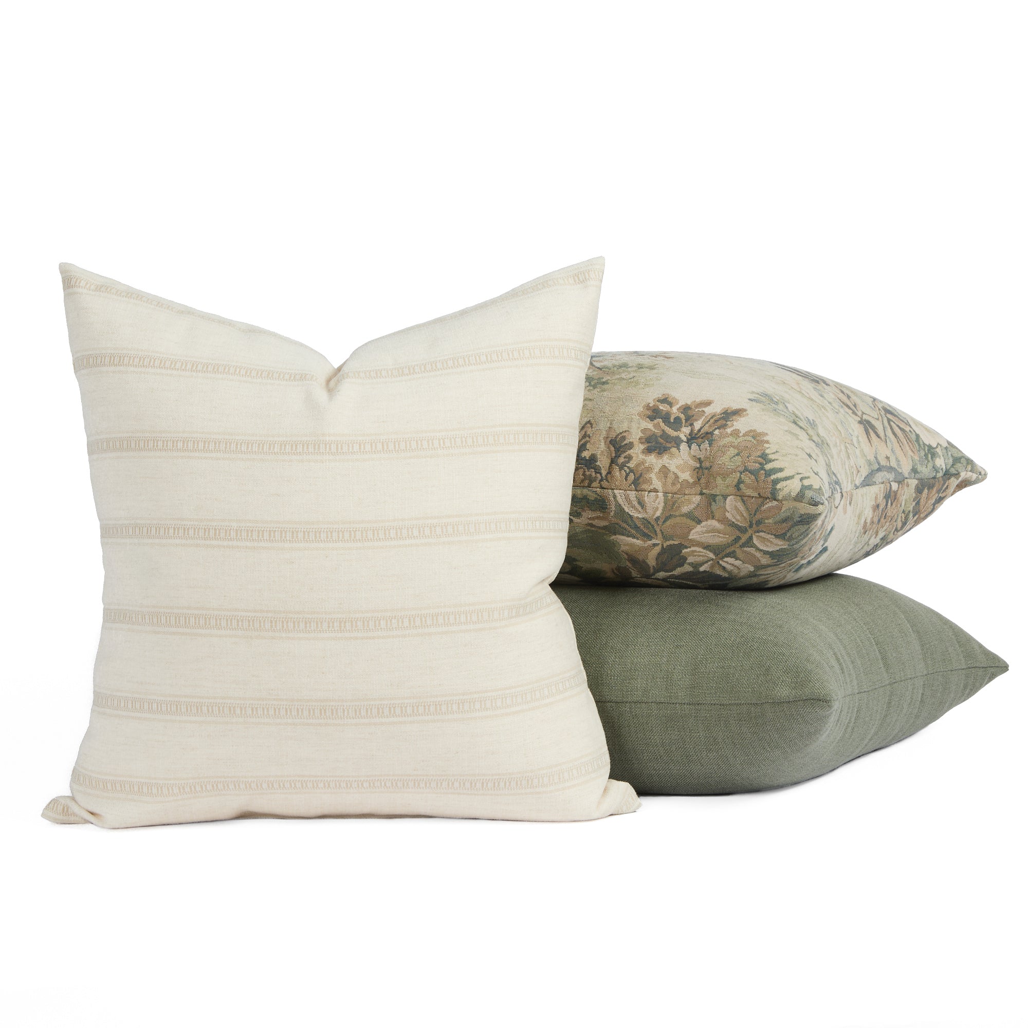 Tonic Living Brunswick cream pillow centred in front of two green-toned cushions for a layered look.